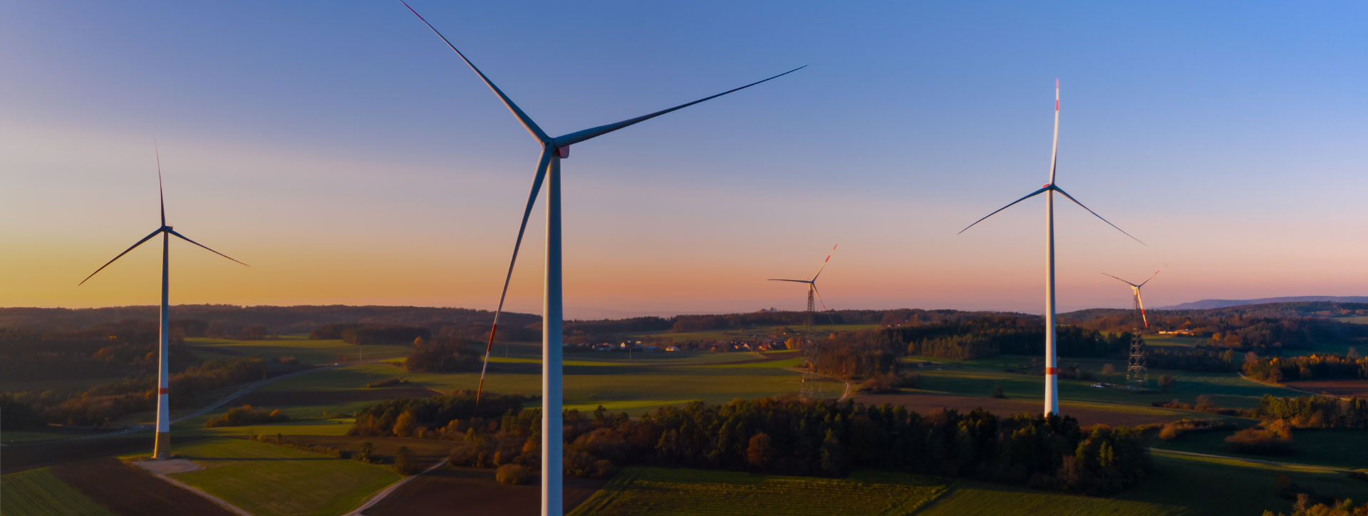 Aerial view of five wind turbines in a farm