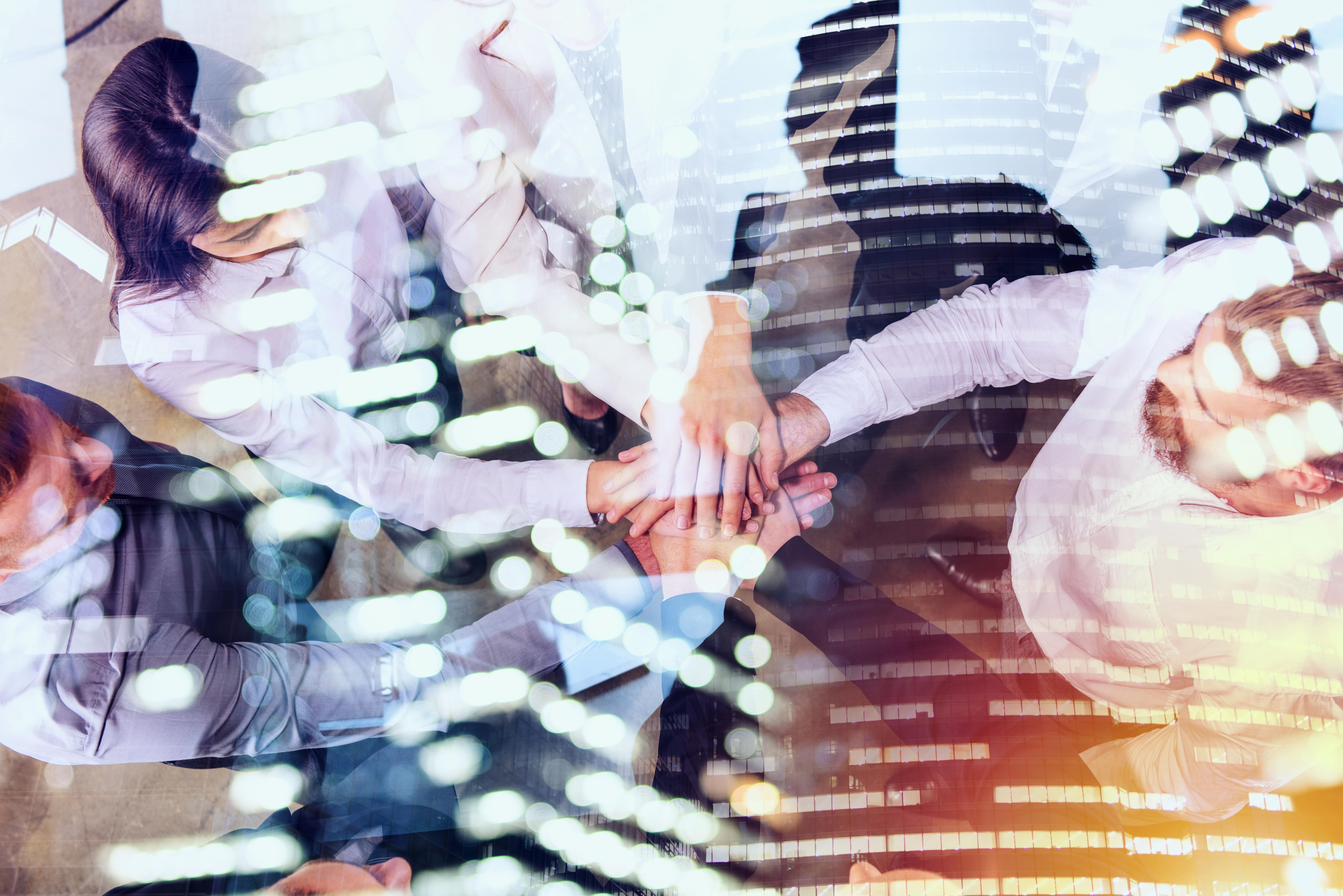 Organization people are putting their hands together to do the work as a team