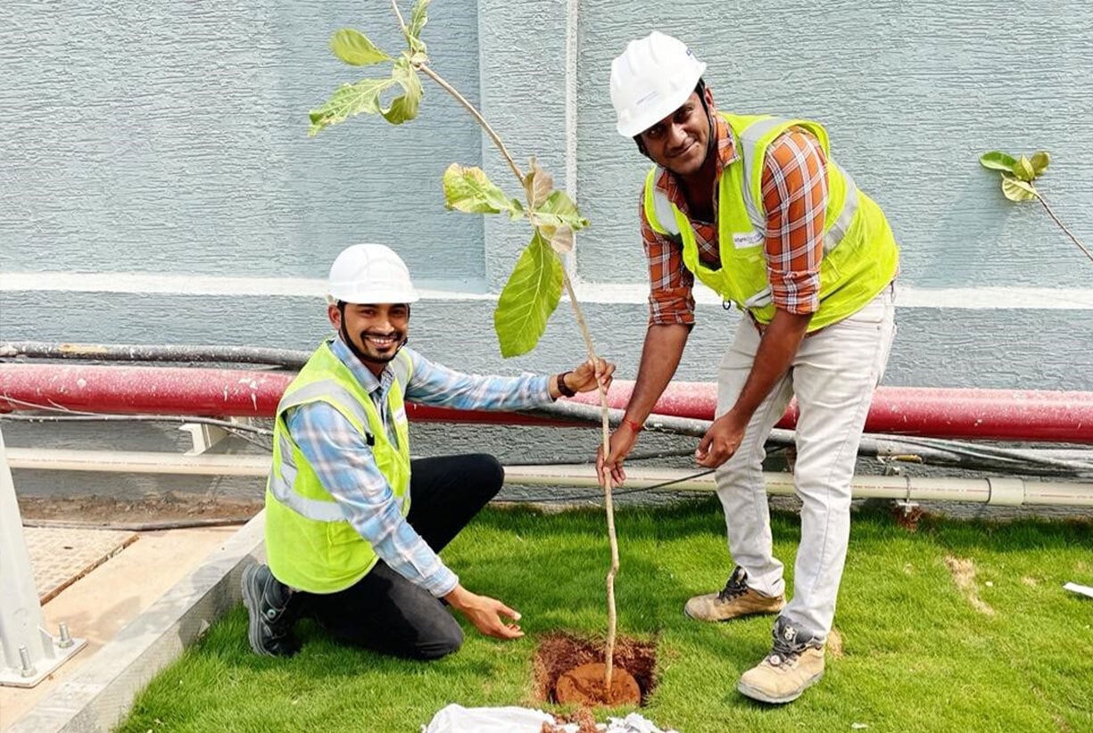 AdaniConneX Team members planting a tree on Environment Day