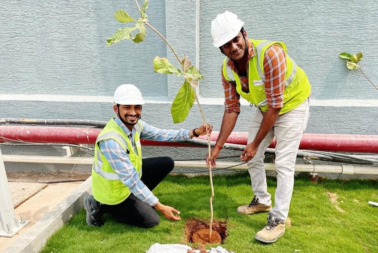 AdaniConneX Team members planting a tree on Environment Day